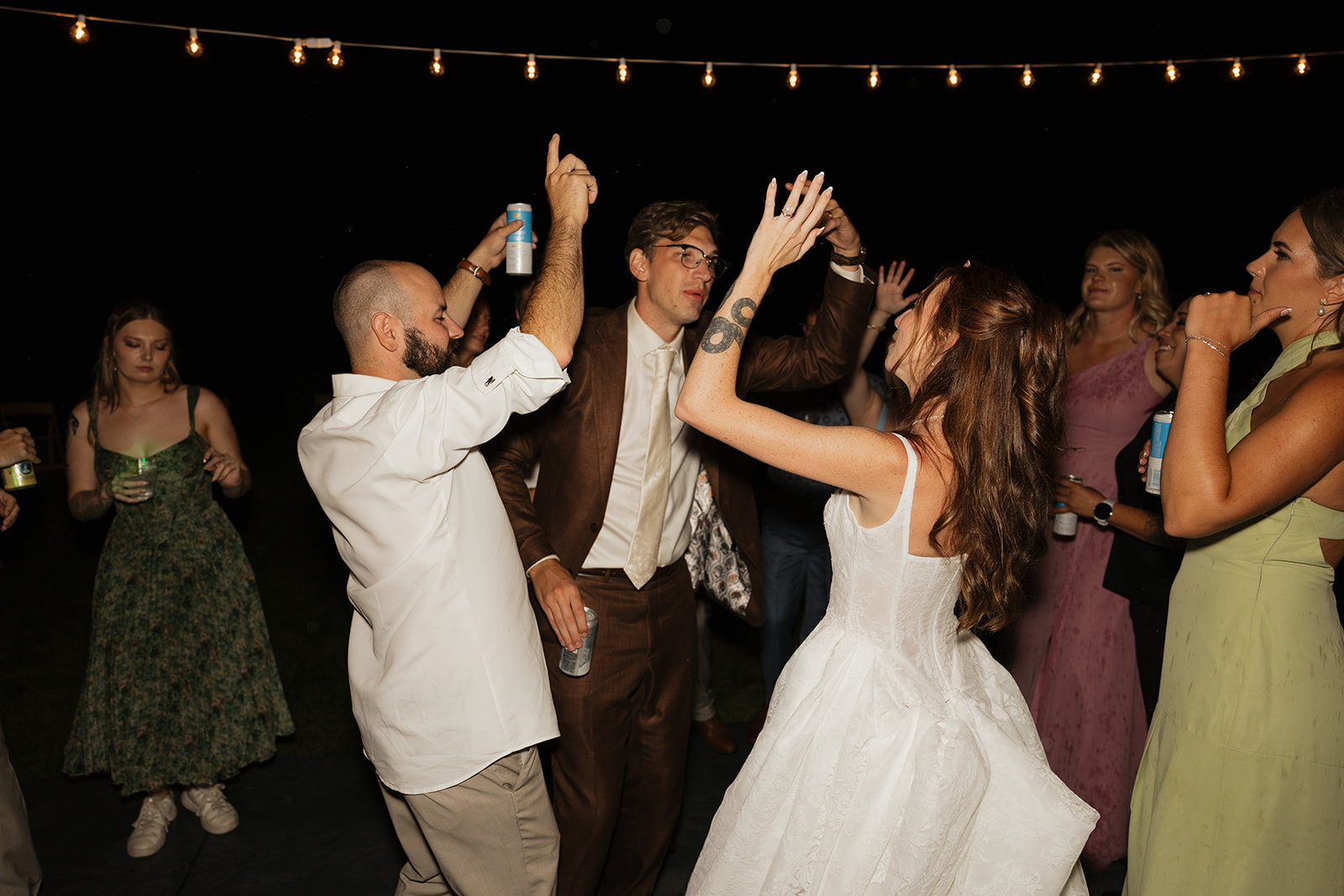 Bride dancing in the middle of a packed outdoor dance floor